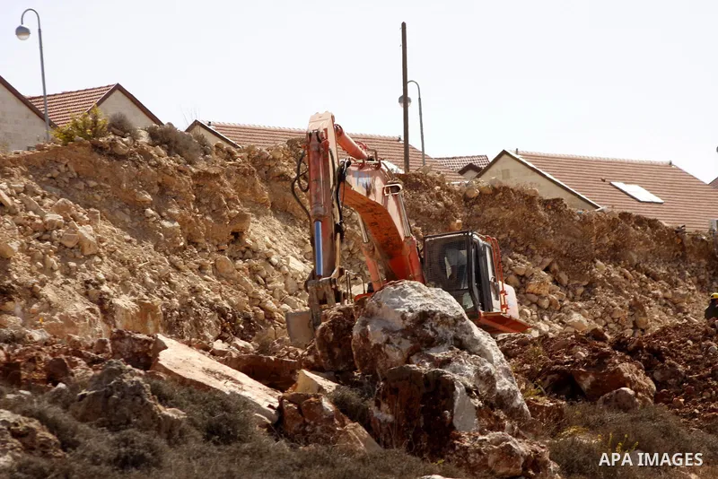 Israeli bulldozers work on the site of a new housing project in the Jewish settlement of Karmi Tsur near the West Bank city of Hebron, Oct. 13, 2010, after reported plans to build 238 new settler homes in annexed Arab ea...