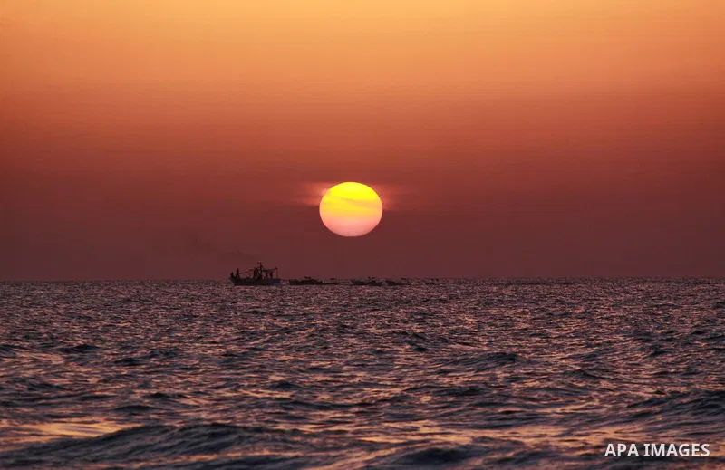 Palestinian fishermen pull their nets at the beach during sunset in Gaza City beach on Oct. 18,2010 . Photo by Mohammed Asad