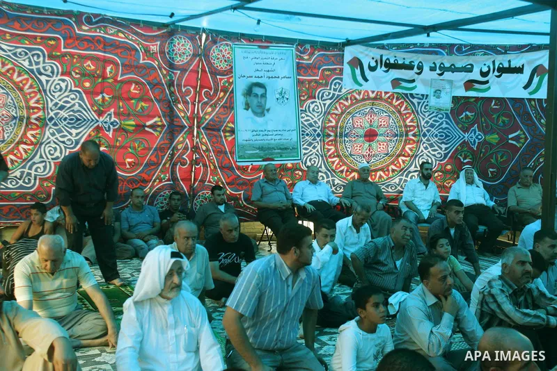 Palestinians attend Friday prayer inside a protest tent on October 22, 2010 in the flashpoint Arab east Jerusalem neighbourhood of Silwan, home to some hundreds of Jewish settlers.. Photo by Mahfouz Abu Turk
