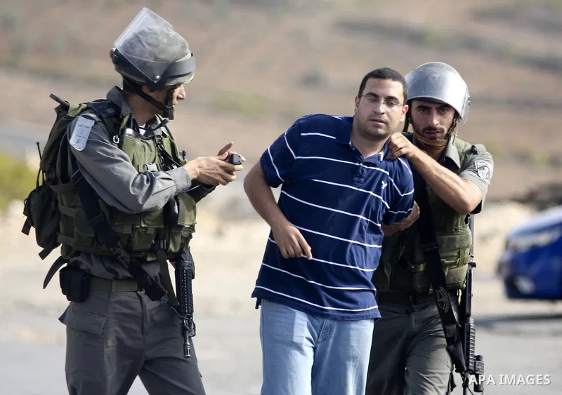 Israeli border policemen arrest two Palestinian men during clashes in the West Bank village of Nabi Saleh, on 22 October 2010. Palestinians protest weekly against the neighbouring Jewish settlement of Halamish. Photo by...