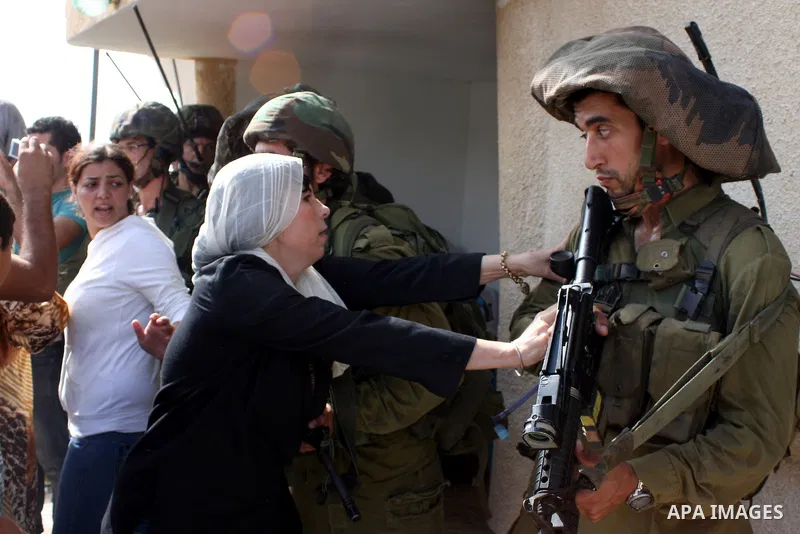 A Palestinian woman scuffles with Israeli border policemen during clashes in the West Bank village of Nabi Saleh, on 22 October 2010. Palestinians protest weekly against the neighbouring Jewish settlement of Halamish. Ph...