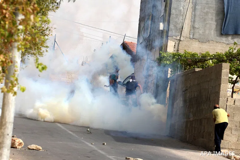 Israeli border policemen fire tear gas canisters towards Palestinians during clashes in the West Bank village of Nabi Saleh, on 22 October 2010. Palestinians protest weekly against the neighbouring Jewish settlement of H...