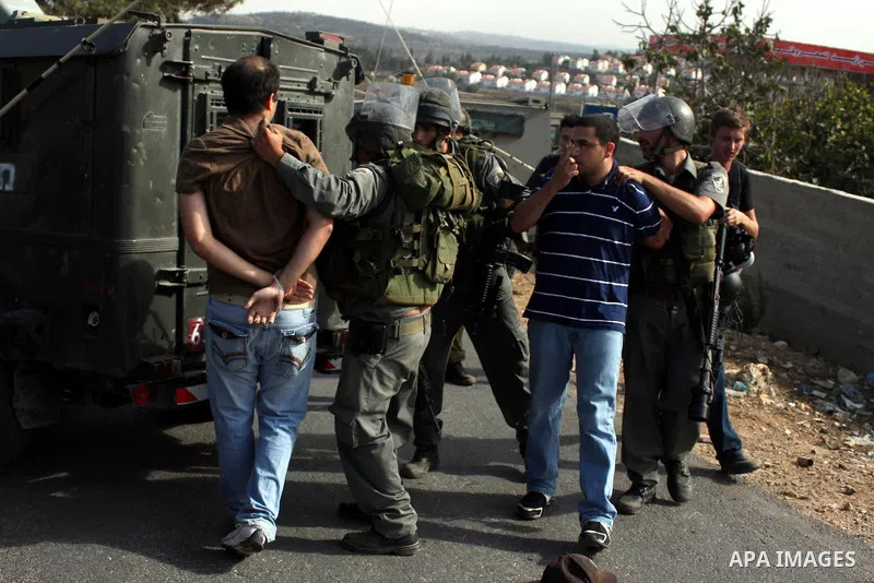 Israeli border policemen arrest two Palestinian men during clashes in the West Bank village of Nabi Saleh, on 22 October 2010. Palestinians protest weekly against the neighbouring Jewish settlement of Halamish. Photo by...