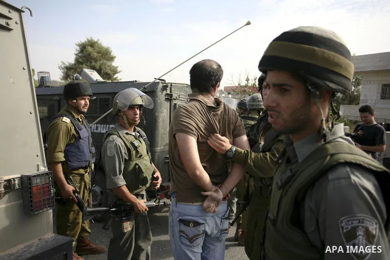 Israeli border policemen arrest two Palestinian men during clashes in the West Bank village of Nabi Saleh, on 22 October 2010. Palestinians protest weekly against the neighbouring Jewish settlement of Halamish. Photo by...