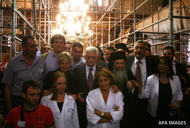 Palestinian President Mahmud Abbas is flanked by Greek Orthodox Patriarch of Jerusalem Theophilos III and other unidentified local officials during his visit on 25 October 2010 to the Church of the Nativity, believed by...