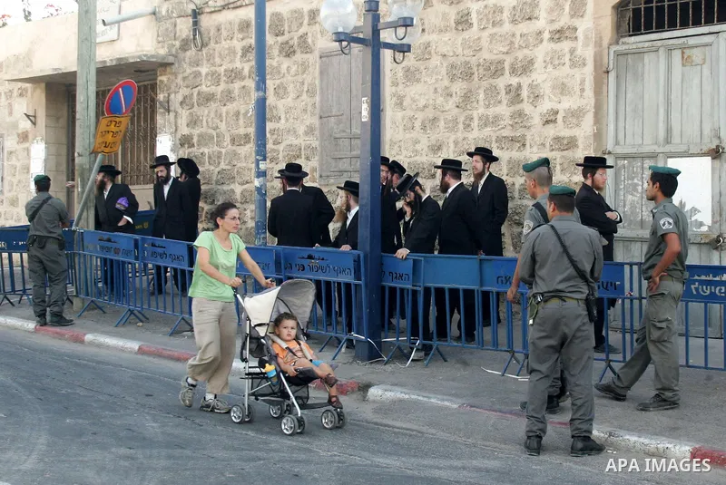 An ultra-Orthodox Jew is grabbed by an Israeli Border policeman during a protest in the coastal town of Jaffa, just south of Tel Aviv, on Oct. 25,2010 over the town's decision to remove ancient graves found during the co...