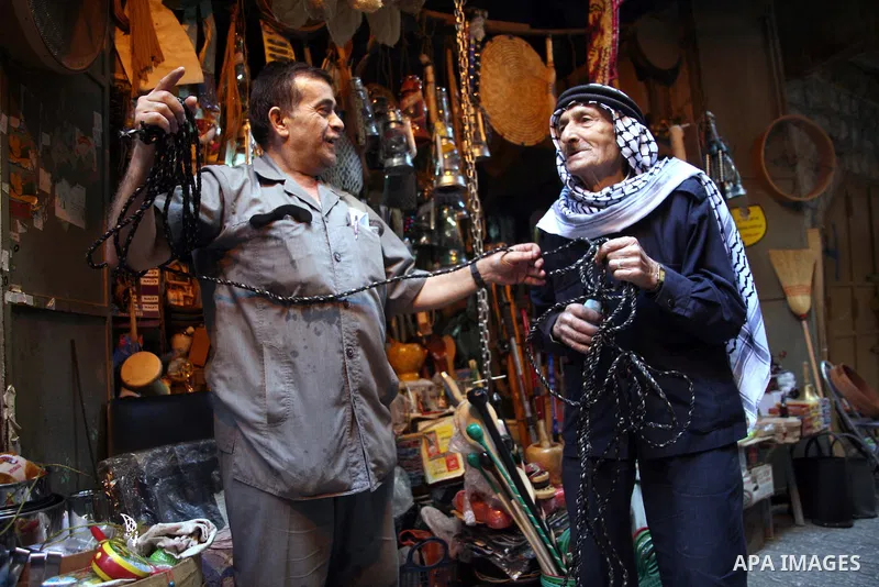 Palestinians shop in a traditional market at the old city in the West Bank city of Hebron on October 28, 2010. Photo by Najeh Hashlamoun