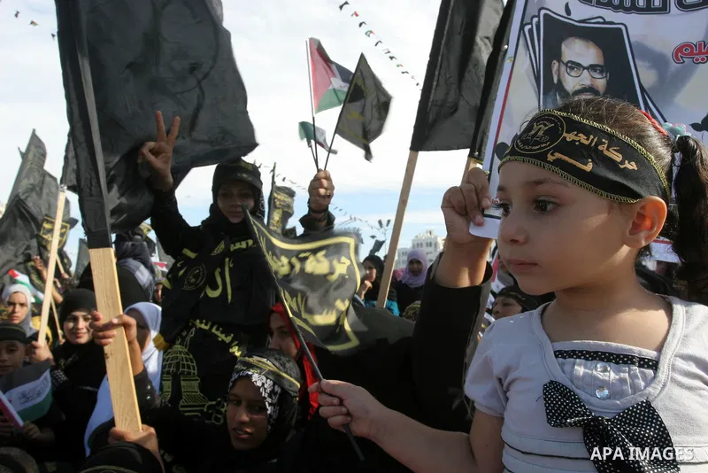 Palestinian Islamic Jihad supporters attend a rally to mark the 23rd anniversary of the establishment of the Islamic Jihad movement and the assassination of the founder of their movement Fathi Shiqaqi , in Gaza city on O...