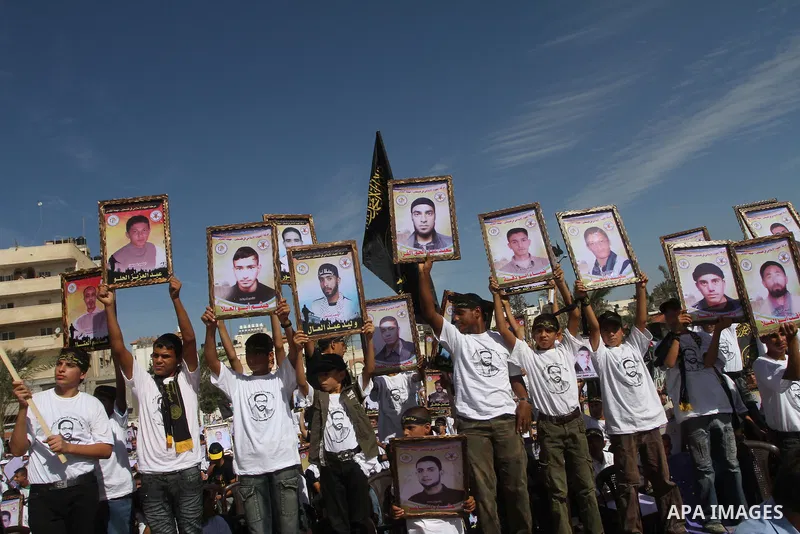 Palestinian Islamic Jihad supporters attend a rally to mark the 23rd anniversary of the establishment of the Islamic Jihad movement and the assassination of the founder of their movement Fathi Shiqaqi , in Gaza city on O...