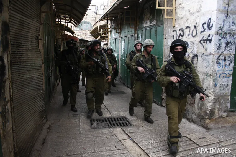Israel soldiers walks in empty streets as the Orthodox Jewish families gathers around their tent where they will spend the night, outside the Tomb of the Patriarchs, traditionally believed to be burial site of the biblic...