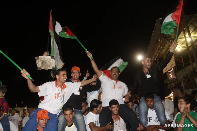 Palestinians celebrate after win on the four British cities in the athlete race, in Gaza City on Oct. 31,2010 . "GAZA 100" aspire to has more than 2000 contestant to enter the Guinness Book of Records .This effectiveness...