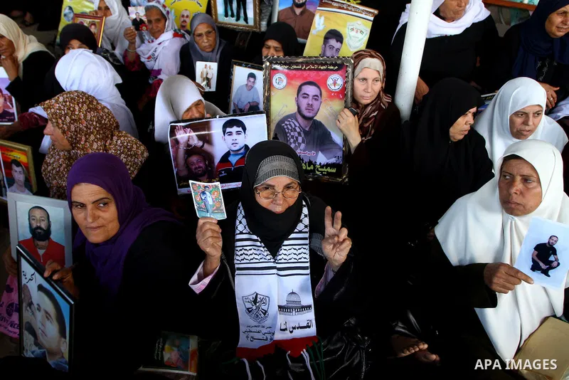 Palestinian women and children hold pictures of jailed relatives during a protest calling for the release of Palestinian prisoners from Israeli jails at the Red Cross office in Gaza City on November 1,2010 . Photo by Ash...