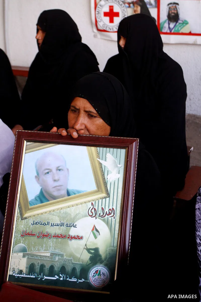 Palestinian women and children hold pictures of jailed relatives during a protest calling for the release of Palestinian prisoners from Israeli jails at the Red Cross office in Gaza City on November 1,2010 . Photo by Ash...