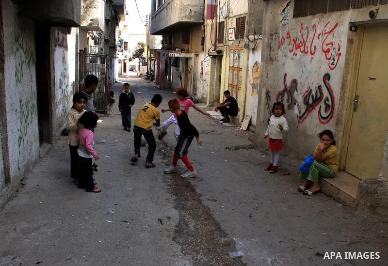 Palestinian children play along a passage of Balata refugee camp near the West Bank city of Nablus, Monday, on Nov. 1, 2010. Photo by Wagdi Eshtayah