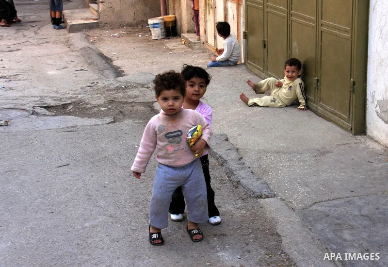 Palestinian children play along a passage of Balata refugee camp near the West Bank city of Nablus, Monday, on Nov. 1, 2010. Photo by Wagdi Eshtayah