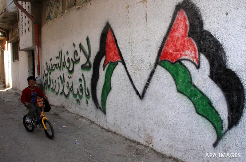 A Palestinian child plays along a passage of Balata refugee camp near the West Bank city of Nablus, Monday, on Nov. 1, 2010. Photo by Wagdi Eshtayah