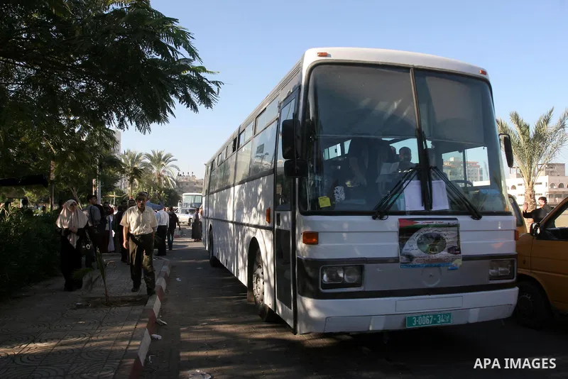 Palestinian pilgrims sit in buses as they wait to cross the Rafah border crossing into Egypt , in Gaza City on Nov. 3,2010 . Hundreds of Palestinian pilgrims crossed into Egypt on their way to Saudi Arabia to perform the...