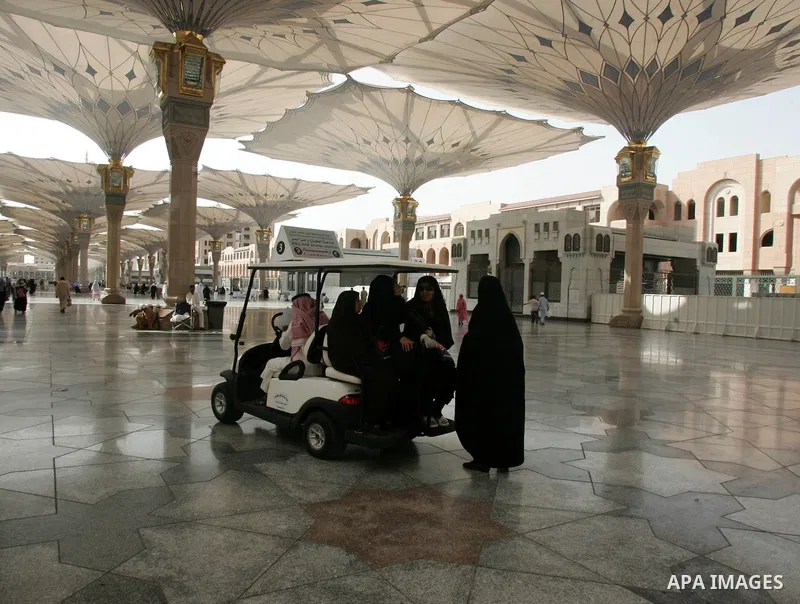 Muslim pilgrims walk outside the Prophet Mohammed Mosque in the Saudi holy city of Medina on November 2, 2010. More than three million Muslims are expected to converge on the holy cities of Mecca and Medina in western Sa...