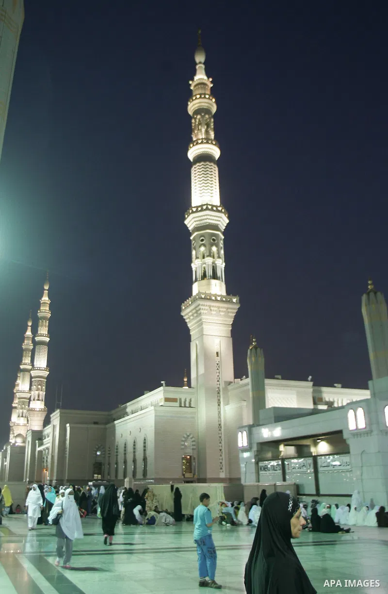 Muslim pilgrims walk outside the Prophet Mohammed Mosque in the Saudi holy city of Medina on November 3, 2010. More than three million Muslims are expected to converge on the holy cities of Mecca and Medina in western Sa...