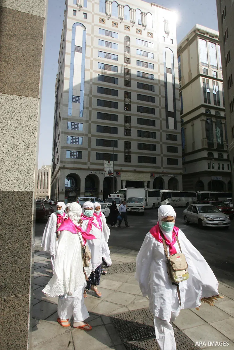 Muslim pilgrims walk outside the Prophet Mohammed Mosque in the Saudi holy city of Medina on November 3, 2010. More than three million Muslims are expected to converge on the holy cities of Mecca and Medina in western Sa...