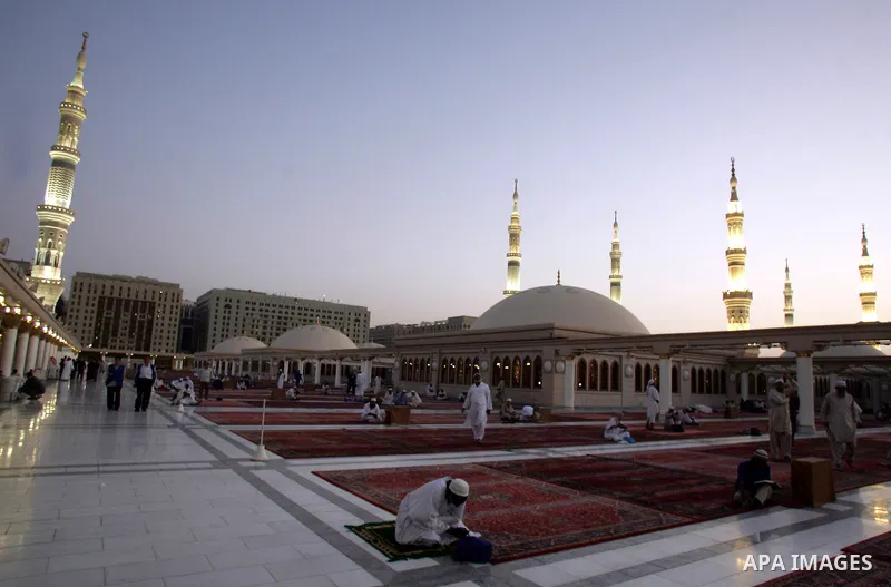 Muslim pilgrims pray outside the Prophet Mohammed Mosque in the Saudi holy city of Medina on November 4, 2010. More than three million Muslims are expected to converge on the holy cities of Mecca and Medina in western Sa...