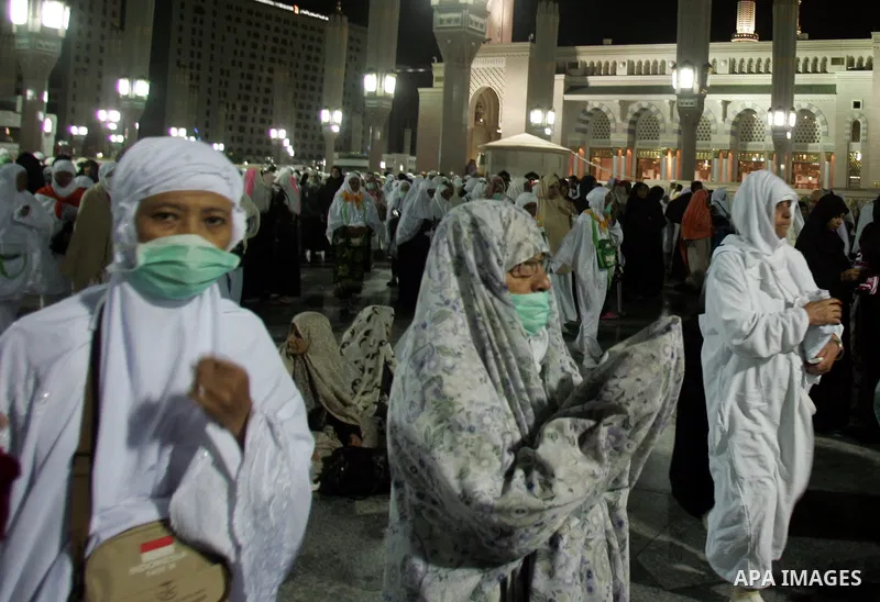 Muslim pilgrims walk outside the Prophet Mohammed Mosque in the Saudi holy city of Medina on November 4, 2010. More than three million Muslims are expected to converge on the holy cities of Mecca and Medina in western Sa...