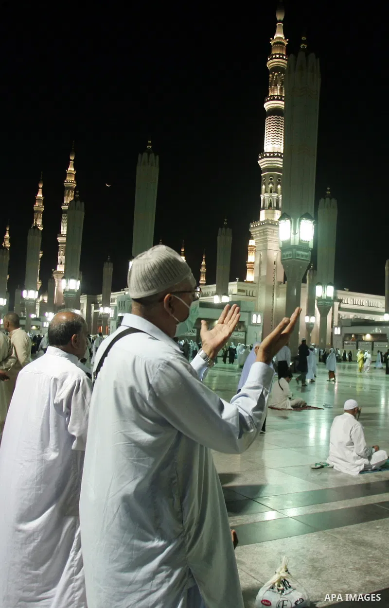 Muslim pilgrims pray outside the Prophet Mohammed Mosque in the Saudi holy city of Medina on November 4, 2010. More than three million Muslims are expected to converge on the holy cities of Mecca and Medina in western Sa...