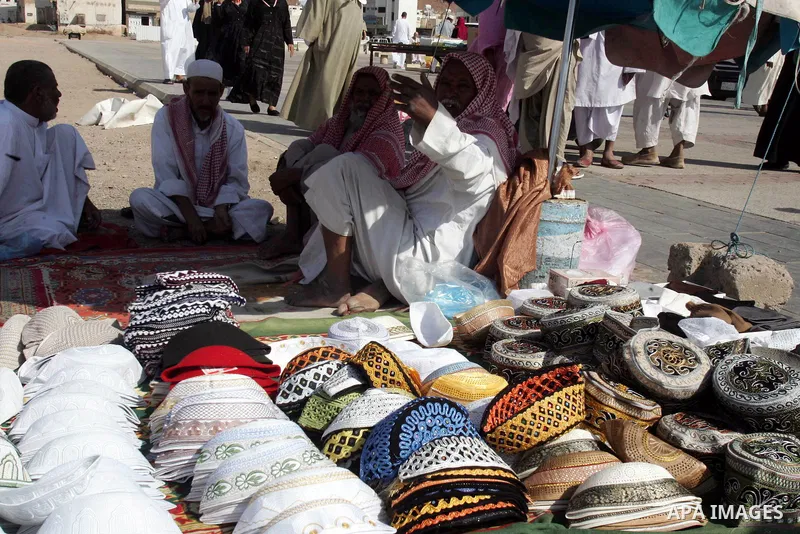 Saudi men sell belongings of pilgrims outside the Prophet Mohammed Mosque in the Saudi holy city of Medina on November 4, 2010. More than three million Muslims are expected to converge on the holy cities of Mecca and Med...
