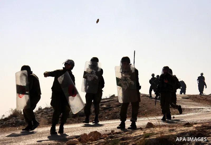 Israeli soldiers take position during a demonstration by Palestinians against Israel's separation barrier in the West Bank village of Bilin near Ramallah, Friday,Nov. 4, 2010. Photo by Wagdi Eshtayah