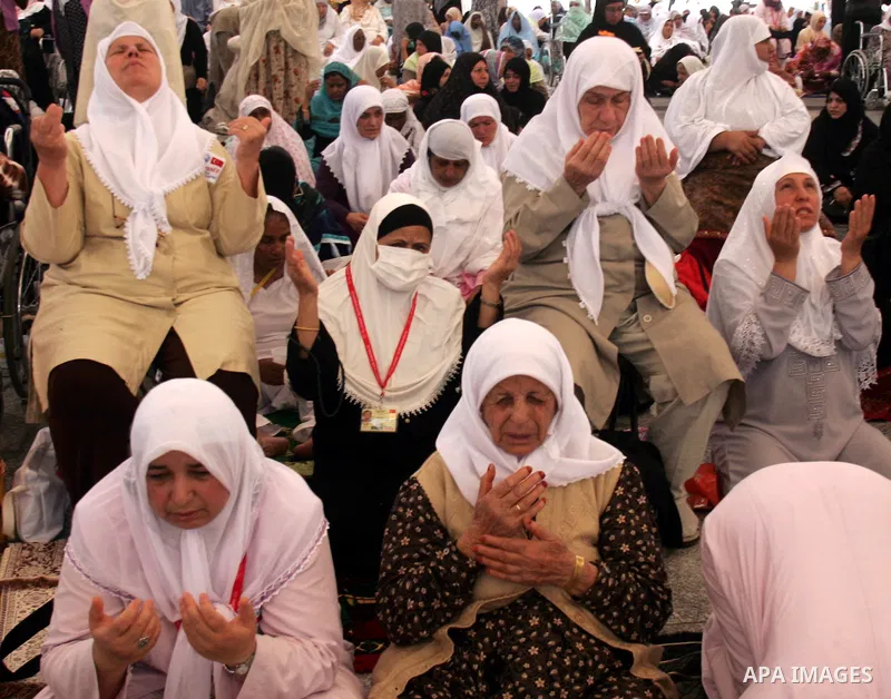 Muslim pilgrims attend Friday prayers outside the Prophet Mohammed Mosque in the Saudi holy city of Medina on November 5, 2010. More than three million Muslims are expected to converge on the holy cities of Mecca and Med...