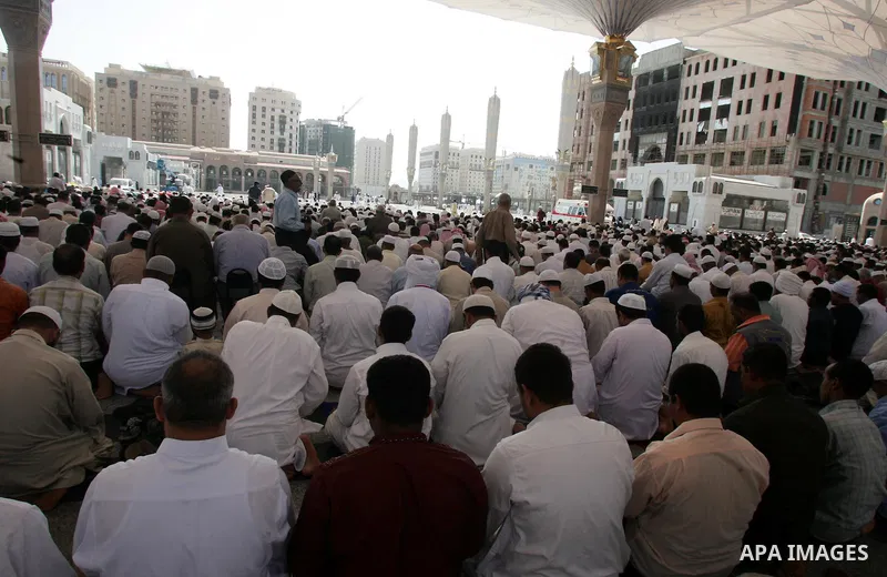 Muslim pilgrims attend Friday prayers outside the Prophet Mohammed Mosque in the Saudi holy city of Medina on November 5, 2010. More than three million Muslims are expected to converge on the holy cities of Mecca and Med...
