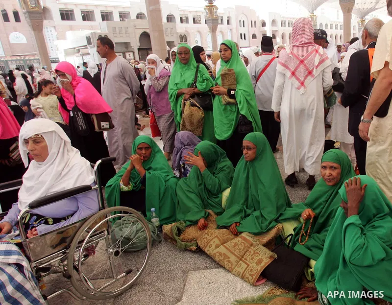 Muslim pilgrims attend Friday prayers outside the Prophet Mohammed Mosque in the Saudi holy city of Medina on November 5, 2010. More than three million Muslims are expected to converge on the holy cities of Mecca and Med...