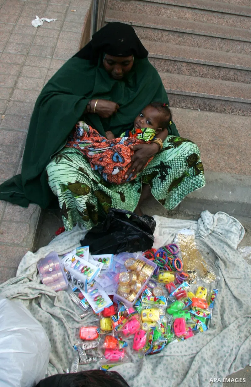 Muslim woaman sells her goods outside the Grand Mosque during the annual Hajj in Mecca, Saudi Arabia, Nov 7, 2010. Some 2.5 million Muslims from more than 160 countries converge annually on the Islamic cities of Mecca an...