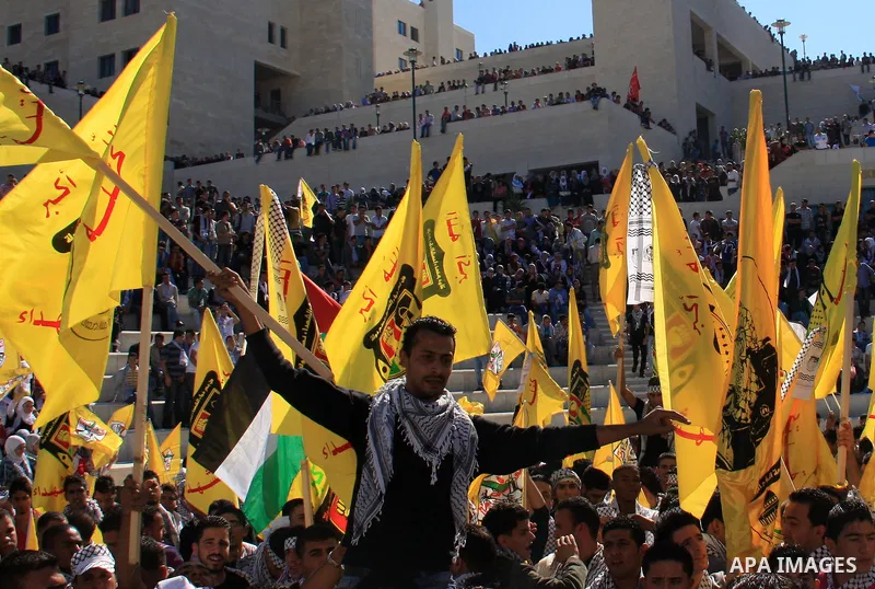 Palestinian students supporters of the Fatah movement wave with the party flag during the celebration of the student council elections at al-Najah University in the West Bank town of Nablus, Monday, Nov. 8, 2010. Photo b...