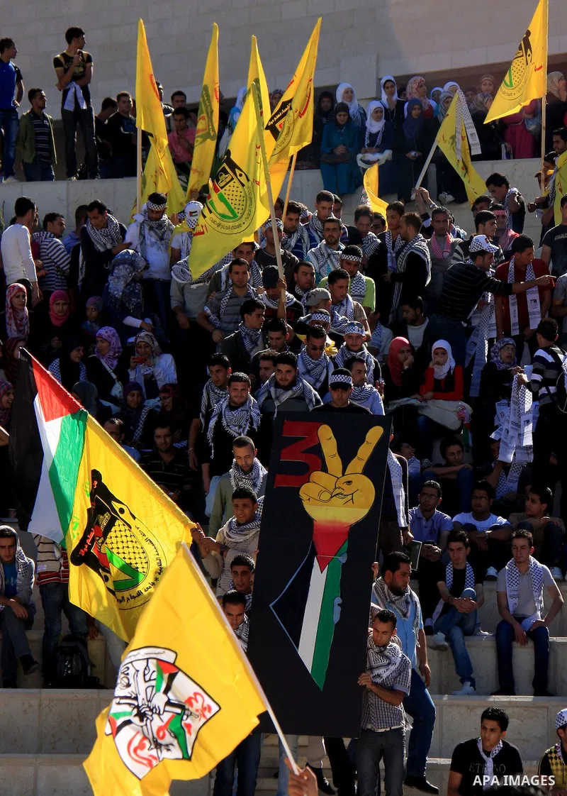 Palestinian students supporters of the Fatah movement wave with the party flag during the celebration of the student council elections at al-Najah University in the West Bank town of Nablus, Monday, Nov. 8, 2010. Photo b...