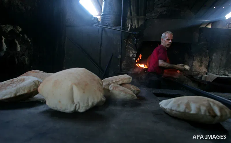 A Palestinian baker prepares loaves of bread at his traditional bakery in southern Gaza Strip town of Rafah , Nov. 9,2010 . Photo By Khaled Khaled