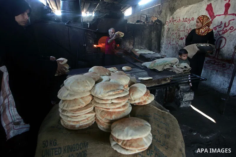 A Palestinian baker prepares loaves of bread at his traditional bakery in southern Gaza Strip town of Rafah , Nov. 9,2010 . Photo By Khaled Khaled