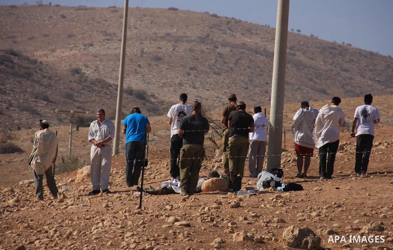 Jewish settlers trying to take control of Palestinian land pray in an area they fenced off in the West Bank village of Tubas, near the Jordan Valley, on November 9, 2010 . Photo by Wagdi Eshtayah