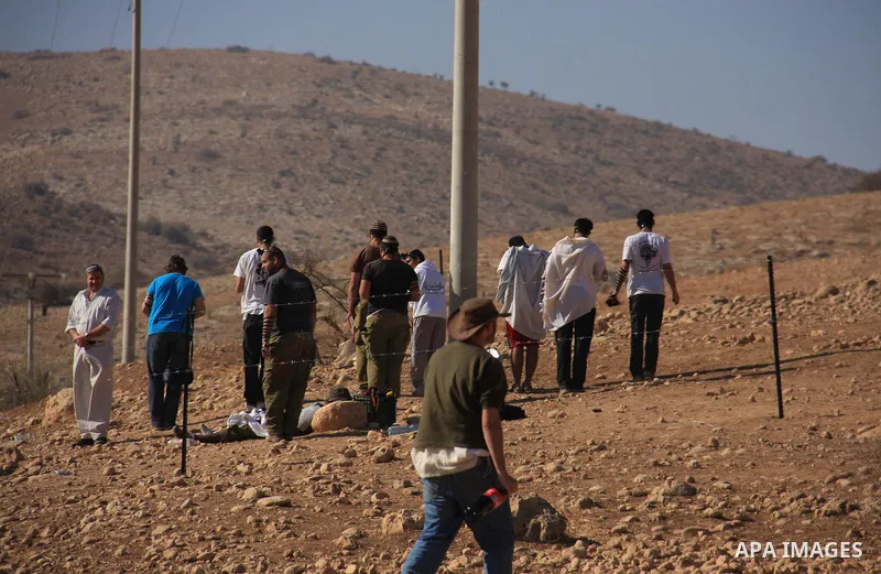 Jewish settlers trying to take control of Palestinian land pray in an area they fenced off in the West Bank village of Tubas, near the Jordan Valley, on November 9, 2010 . Photo by Wagdi Eshtayah