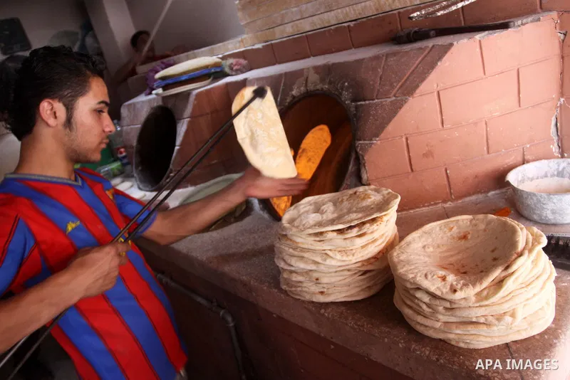 A Palestinian baker prepares loaves of bread at his traditional bakery in Gaza City on Nov. 11,2010 . Israel allowed flour to enter the Gaza Strip for one day only a week, which will lead to a crisis in basic materials f...