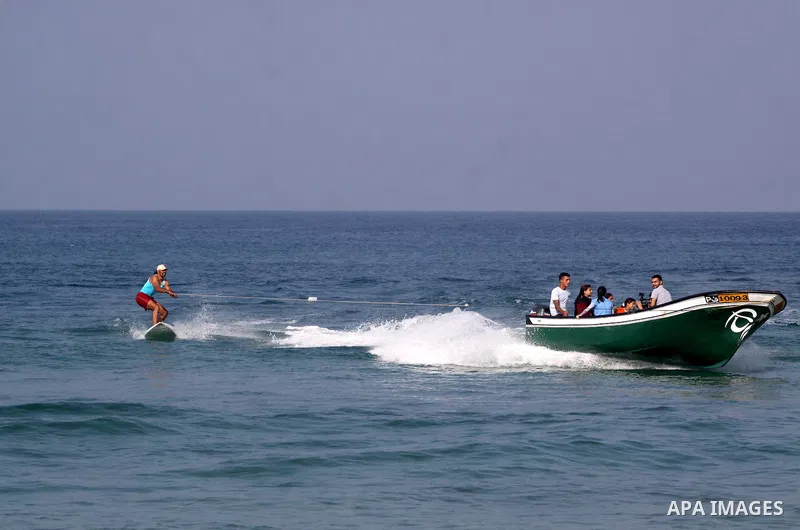 A Palestinian man teach his daughters to ride the waves sport in Gaza city beach on Nov 12,2010.. Photo by Mohammed Asad