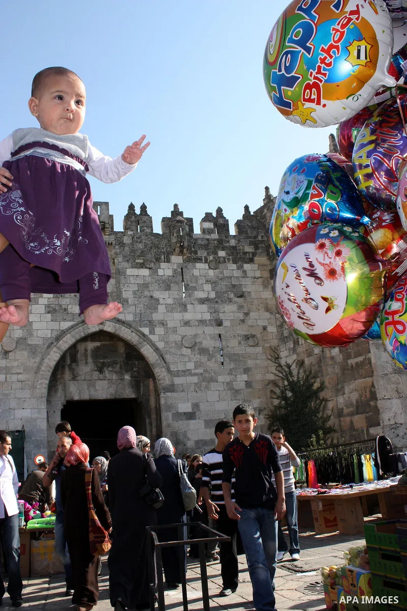 Palestinians celebrate in Jerusalem's old city on the second day of Eid al-Adha,on November, 17, 2010. as Muslims worldwide commemorate Eid al-Adha, or the Feast of the Sacrifice, marking the end of the hajj and commemor...