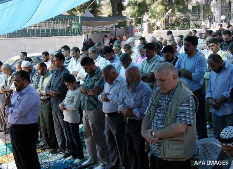 Hamas legislators Khaled Abu Arafa, Ahmed Atun and Mohammed Totah attend Friday prayer inside the Red Cross offices in east Jerusalem on November 19, 2010 as they mark 142 days that the three Hamas MPs are taking refuge...