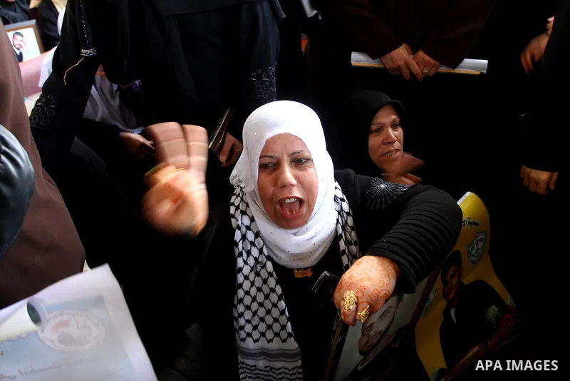 Palestinian women and children hold pictures of jailed relatives during a protest calling for the release of Palestinian prisoners from Israeli jails at the Red Cross office in Gaza City on Nov. 29,2010. Photo by Ashraf...