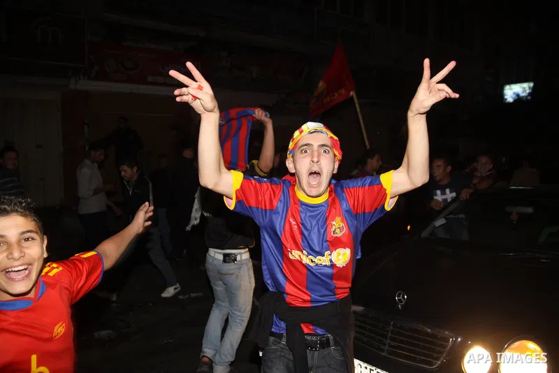 Palestinians youths celebrate the victory of the Spanish team Barcelona , in Gaza City on Nov. 29,2010. Barcelona celebrated their victory after the Spanish La Liga soccer match against Real Madrid with five goals. Photo...