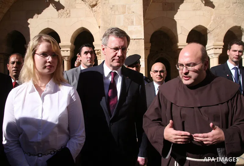German President Christian Wulff (C) listens to an explanation as he visits the Church of the Nativity, believed to be by Christians the birthplace of Jesus Christ, in the West Bank city of Bethlehem on November 30, 2010...