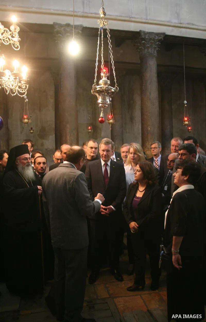 German President Christian Wulff (C) listens to an explanation as he visits the Church of the Nativity, believed to be by Christians the birthplace of Jesus Christ, in the West Bank city of Bethlehem on November 30, 2010...