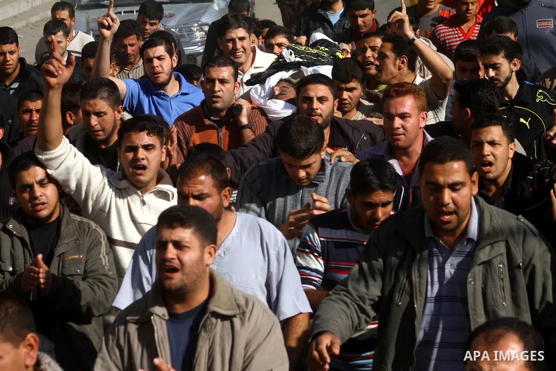 Palestinian mourners carry the body of the Islamic Jihad militant Jihad Nasser who was killed by Israeli fire during his funeral in the Jabaliya refugee camp Northern Gaza Strip, Dec. 3, 2010. The Israeli army shot and k...