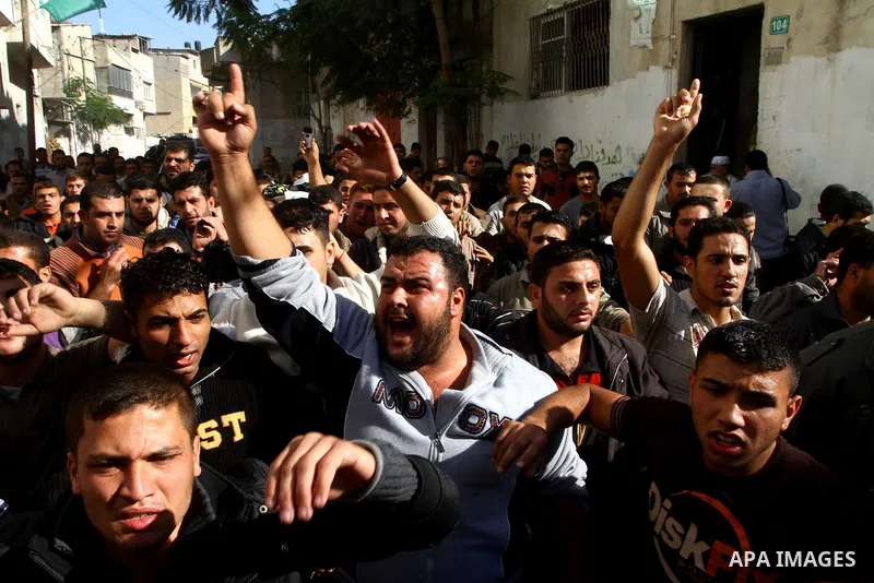Palestinian mourners carry the body of the Islamic Jihad militant Jihad Nasser who was killed by Israeli fire during his funeral in the Jabaliya refugee camp Northern Gaza Strip, Dec. 3, 2010. The Israeli army shot and k...