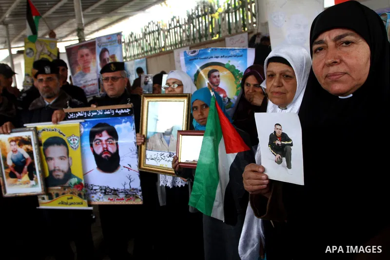 Palestinian security forces in Gaza Strip attend the weekly protest by families of prisoners in the Israeli jails at the Red Cross headquarters in Gaza City, on Dec. 6, 2010. Families of prisoners and the Palestinians se...